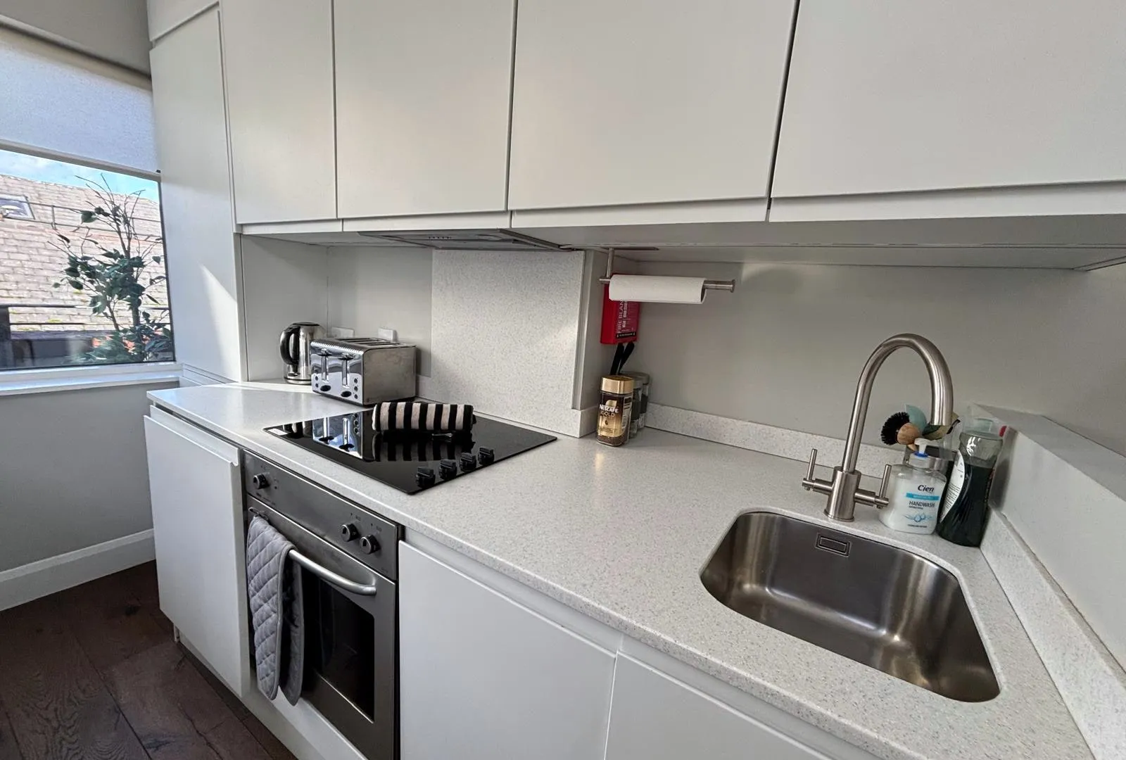 Kitchen worktop, hob and sink after a turnover clean