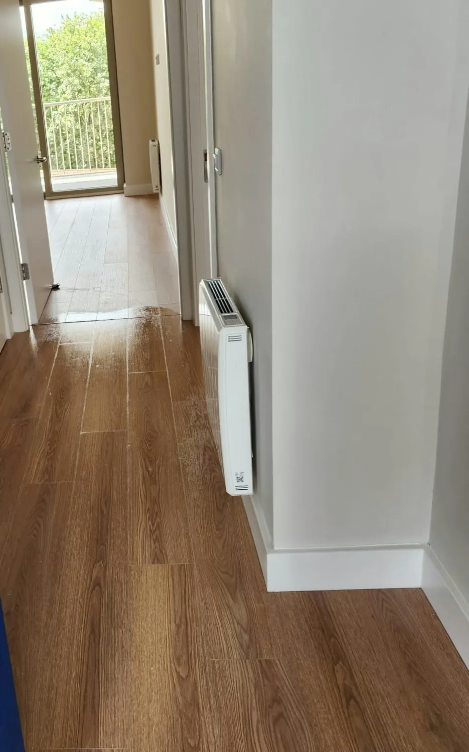 The same hallway after an after builders clean, floor washed and debris cleared